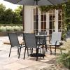 Flash Furniture Brazos Commercial Outdoor Dining Set, 47″ Tempered Glass Patio Table with Umbrella Hole, 4 Stack Chairs with Flex Comfort Seats and Backs, Navy/Black(Grey)